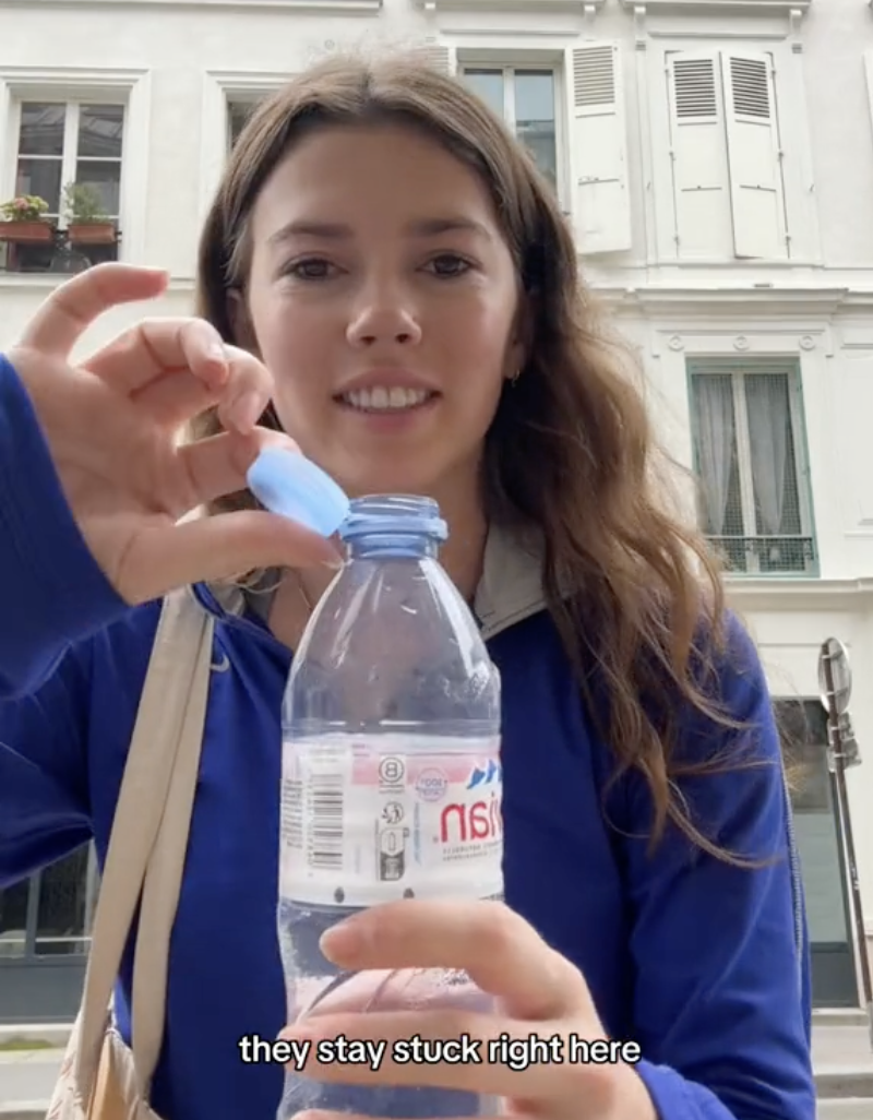 Woman in a TikTok video holding a tethered water bottle